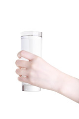 Beautiful female hand holding a glass of water isolated on white