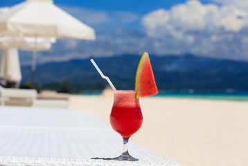 watermelon cocktail on blue tropical beach