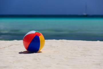 child ball on sand beach