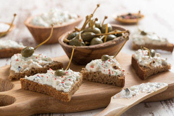 toasts with cheese pate and capers, selective focus