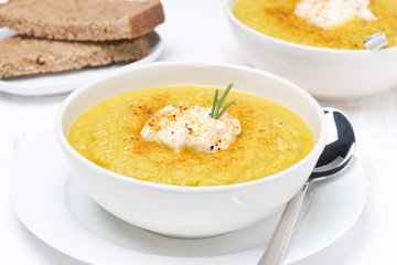 vegetable soup with cream and rosemary in a bowl