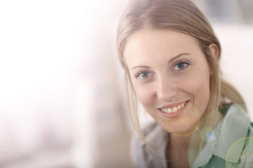 Portrait of beautiful office-worker sitting at desk