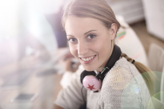 Blond Girl In Class With Music Headphones On