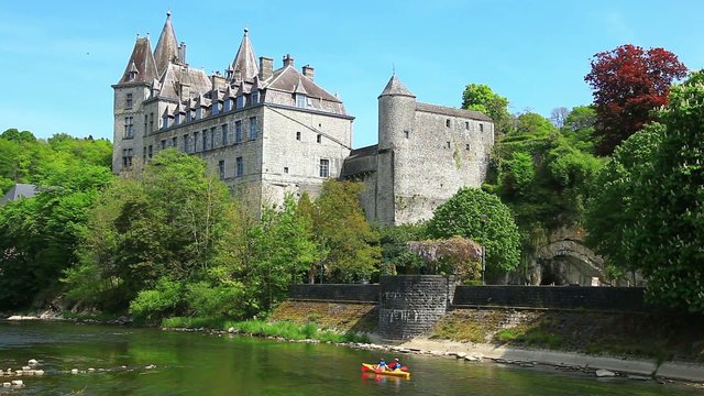 Kayak sails past the castle in the city Durbuy