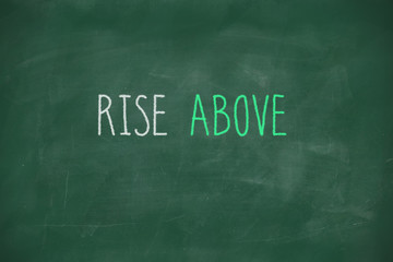 Rise above handwritten on blackboard