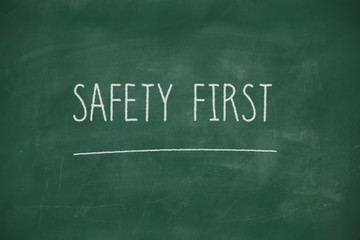 Safety first handwritten on blackboard