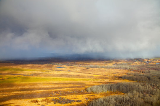 Snowfall running from cloud during end of autumn, top view