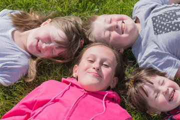 four children on the grass, outdoors