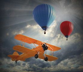 Retro style picture of the biplane and hot air balloons.