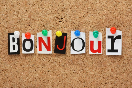 The word Bonjour on a cork notice board
