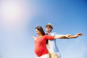 Pregnant couple with blue sky