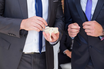 Best man gives rings to the groom