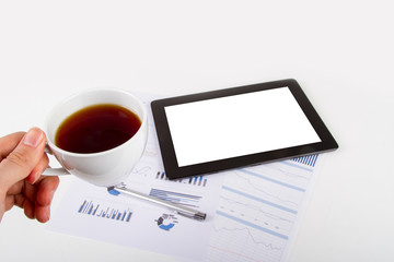 Tablet, Tea on Financial Graph Charts