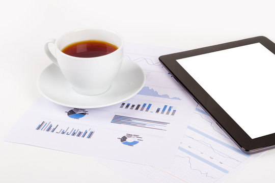 Tablet, Tea on Financial Graph Charts