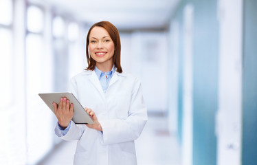 Fototapeta na wymiar smiling female doctor and tablet pc computer