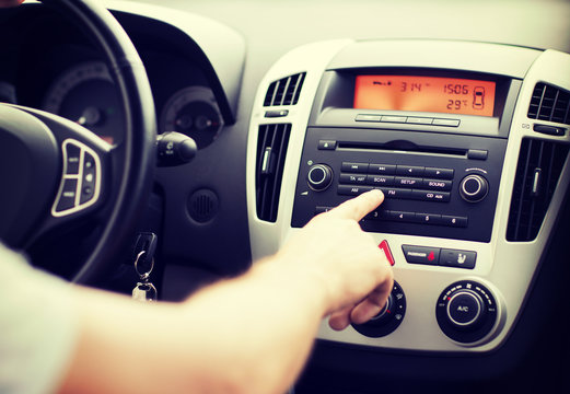 Man Using Car Audio Stereo System