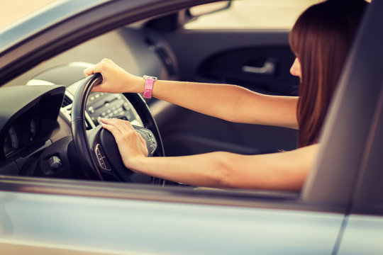 Woman Driving A Car With Hand On Horn Button