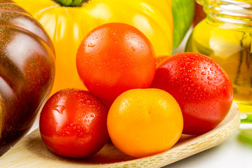 Varieties of colorful tomatos and olive oil