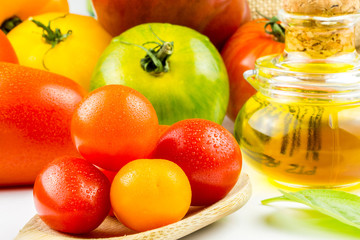 Varieties of colorful tomatos and olive oil
