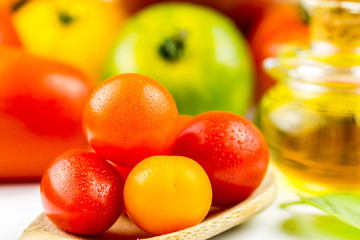 Varieties of colorful tomatos and olive oil