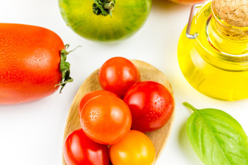 Varieties of colorful tomatos and olive oil