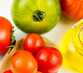 Varieties of colorful tomatos and olive oil