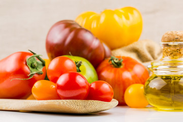 Varieties of colorful tomatos and olive oil