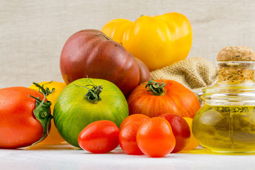 Varieties of colorful tomatos and olive oil