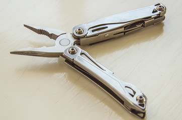 Multi tools on wooden background