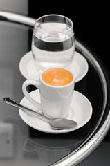 Espresso coffee and glass of water on top table