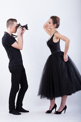 Side view of a photographer and female model
