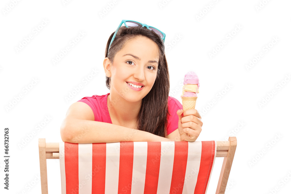 Canvas Prints woman eating ice cream seated on a sun lounger