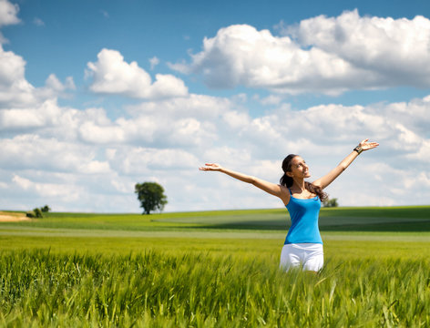 Beautiful woman rejoicing her freedom in nature