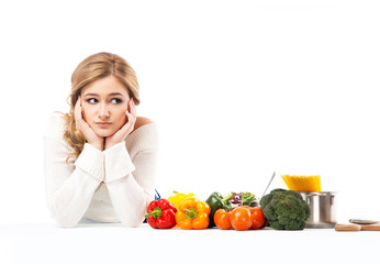 Young and beautiful housewife woman cooking in a kitchen