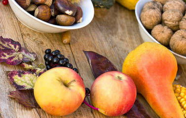 Naklejka na ściany i meble Autumn fruits on table - closeup