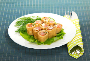 Pancakes with salmon and salad