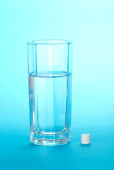 Glass with water and tablets