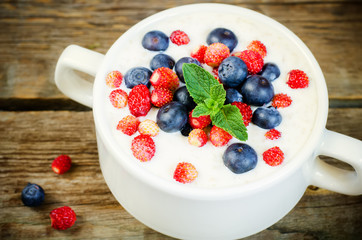 oatmeal with blueberries and strawberries in the white bowl