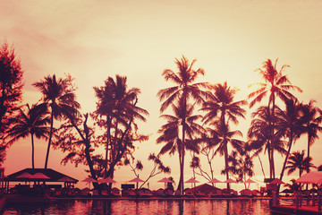 Tropical beach view. Palm tree and red sunset sky.
