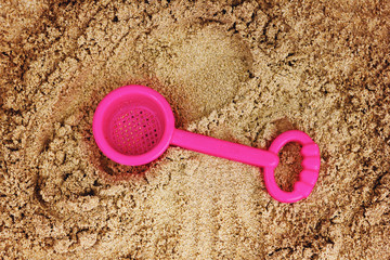 Child`s toy in sandbox