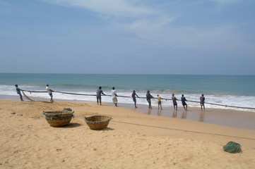 INDURUWA, SRI LANKA - 26 APR 2013: fishermen pull big net i. 