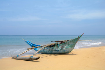 Fototapeta na wymiar Exotic fisherman boat on beach near the ocean