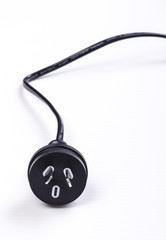 A black Australian power cord plug on white background