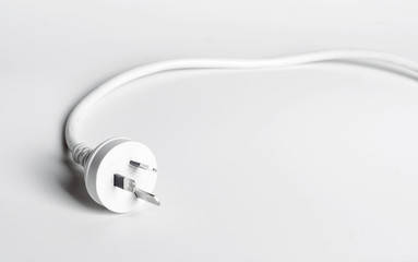 A white Australian power cord plug on white background