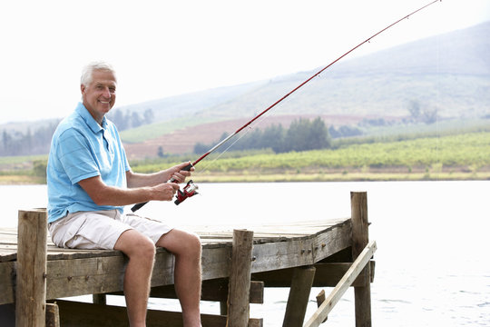 Senior Man Fishing On Jetty