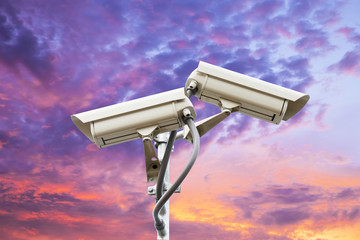 Security camera on colorful sky background