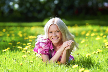 Fototapeta premium Woman laying on flower meadow