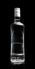 Bottle of vodka standing isolated on black background