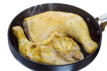 Two chicken legs on a hot pan