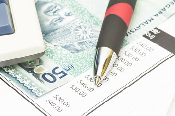 Ball pen, bank note and bank statement - financial concept